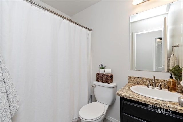 bathroom featuring toilet and vanity