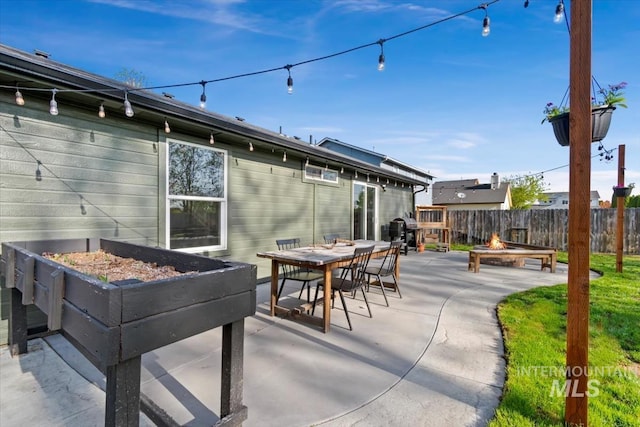 exterior space with a patio, fence, a fire pit, and outdoor dining space