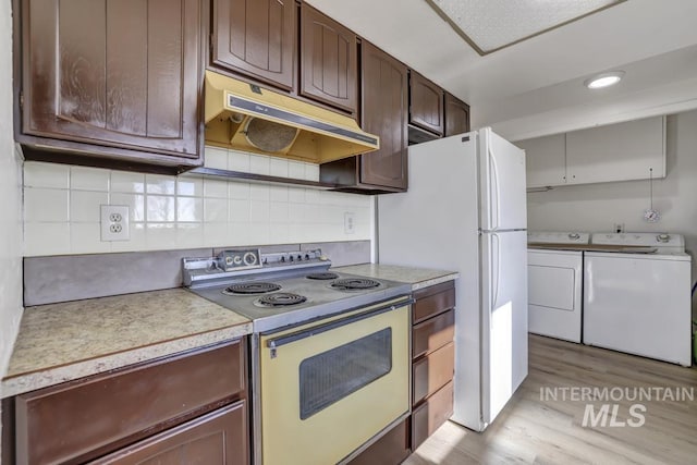 kitchen with dark brown cabinetry, backsplash, white appliances, washer and dryer, and light wood-type flooring