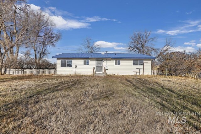 rear view of property with a yard