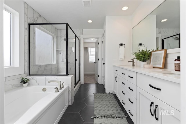 full bathroom featuring double vanity, visible vents, tile patterned flooring, a shower stall, and a bath