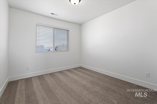 carpeted empty room with baseboards and visible vents