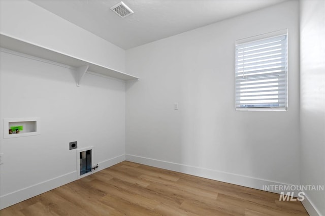 laundry area with hookup for a washing machine, visible vents, light wood-style floors, laundry area, and baseboards