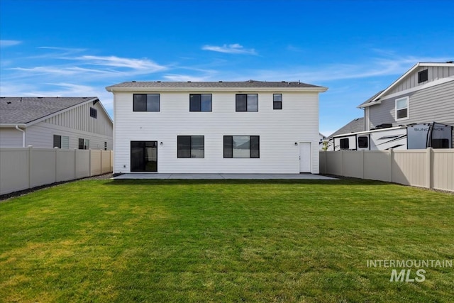 back of house featuring a fenced backyard, a lawn, and a patio