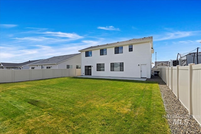 back of house featuring a patio area, a fenced backyard, and a yard