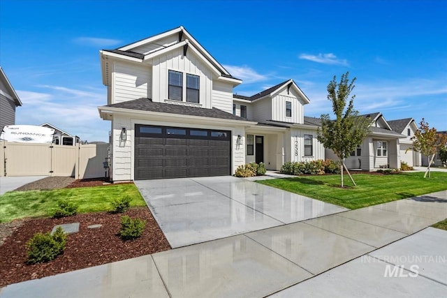 view of front of property with a garage, fence, concrete driveway, a gate, and board and batten siding