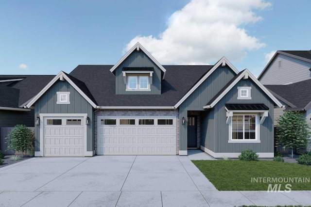 craftsman house featuring board and batten siding, roof with shingles, a front yard, driveway, and an attached garage