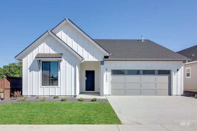 modern inspired farmhouse featuring a front yard and a garage