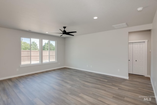 spare room with ceiling fan and wood-type flooring