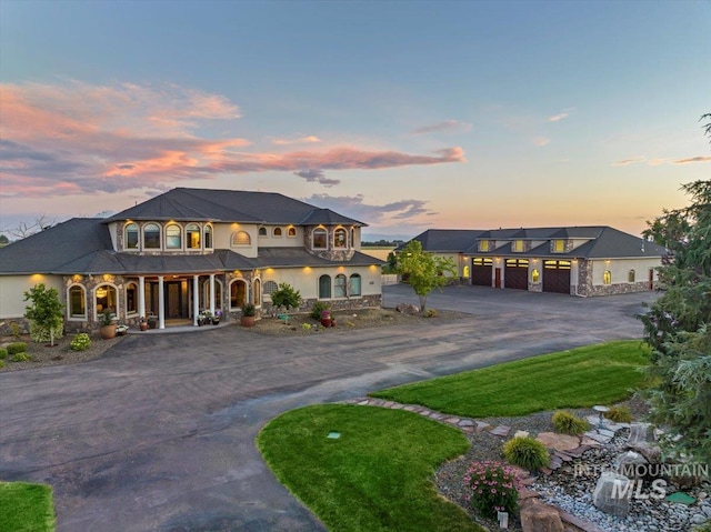 9105 W Mcmillan, Nampa, ID 83687 - view of front of home with curved driveway, covered porch, and stone siding