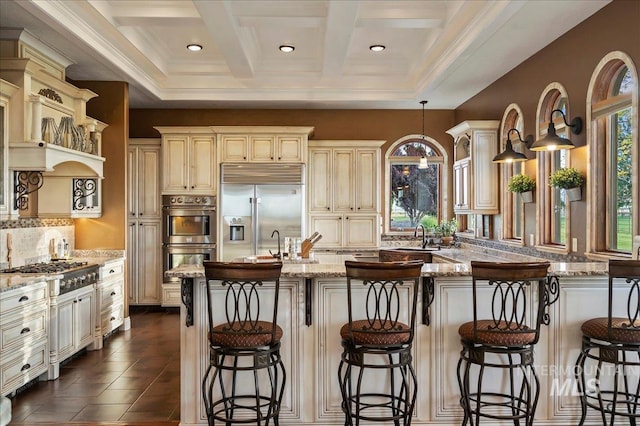 9105 W Mcmillan, Nampa, ID 83687 - kitchen with cream cabinets, appliances with stainless steel finishes, tasteful backsplash, light stone counters, and coffered ceiling