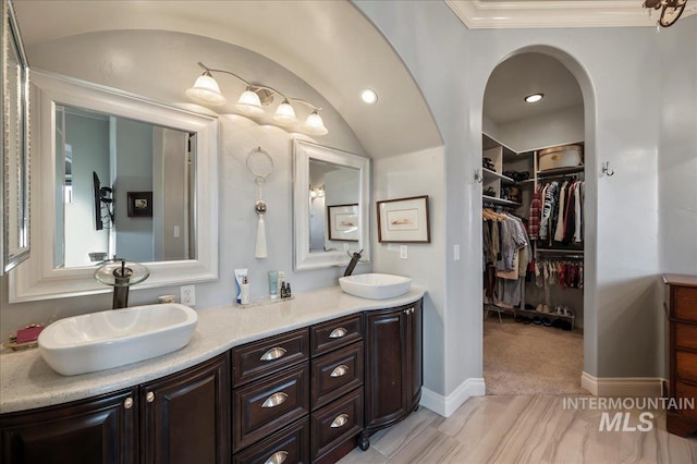 9105 W Mcmillan, Nampa, ID 83687 - full bathroom featuring double vanity, a walk in closet, and ornamental molding