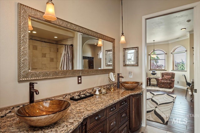 9105 W Mcmillan, Nampa, ID 83687 - full bath featuring double vanity, crown molding, a shower with shower curtain, and wood finished floors