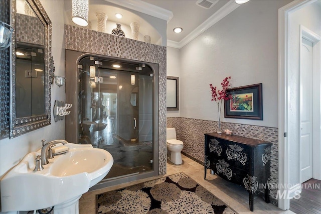 9105 W Mcmillan, Nampa, ID 83687 - full bath featuring crown molding, a stall shower, toilet, tile walls, and a sink