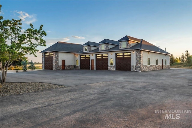 9105 W Mcmillan, Nampa, ID 83687 - view of front of property with stone siding, driveway, and stucco siding