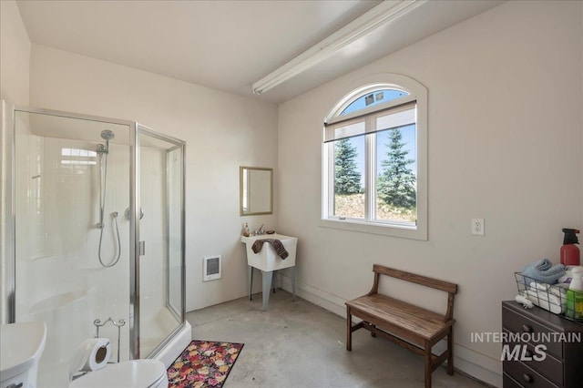 9105 W Mcmillan, Nampa, ID 83687 - bathroom featuring a shower stall, concrete flooring, toilet, heating unit, and a sink