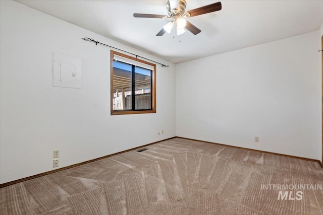 spare room featuring ceiling fan and light colored carpet