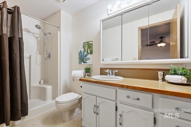 bathroom with toilet, ceiling fan, a shower with shower curtain, and vanity