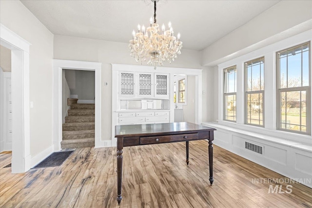 803 4th St S, Nampa, ID 83651 - unfurnished dining area featuring visible vents, plenty of natural light, wood finished floors, and stairs