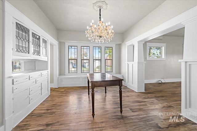 803 4th St S, Nampa, ID 83651 - dining space with dark wood-style flooring, a wealth of natural light, and a notable chandelier