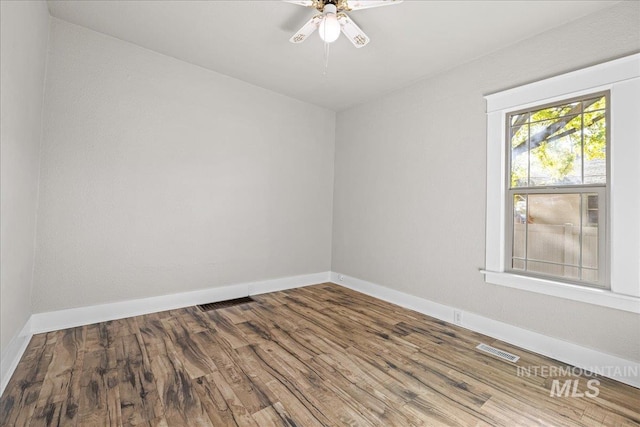 803 4th St S, Nampa, ID 83651 - unfurnished room with visible vents, baseboards, a ceiling fan, and wood finished floors