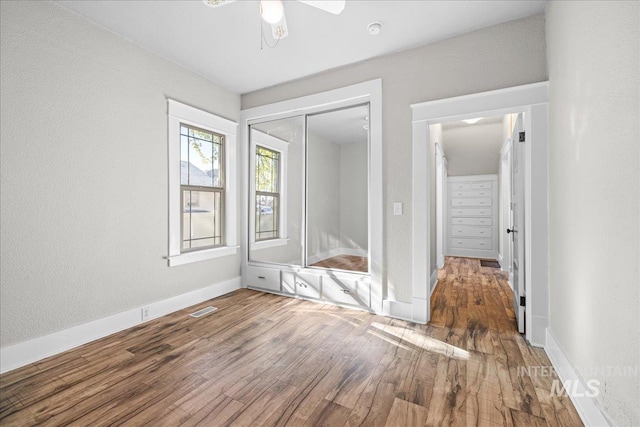 803 4th St S, Nampa, ID 83651 - unfurnished bedroom with a closet, baseboards, a ceiling fan, visible vents, and wood finished floors