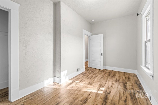803 4th St S, Nampa, ID 83651 - spare room featuring a textured wall, plenty of natural light, and wood finished floors