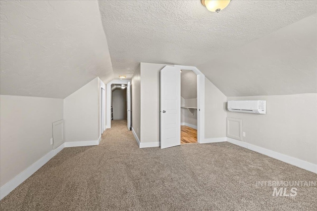 803 4th St S, Nampa, ID 83651 - bonus room featuring baseboards, a wall mounted air conditioner, a textured ceiling, carpet flooring, and lofted ceiling