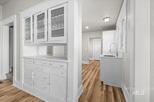 803 4th St S, Nampa, ID 83651 - interior space featuring stairs, light wood-style flooring, baseboards, and a sink