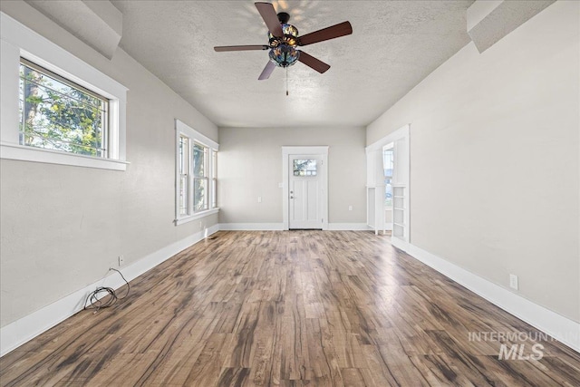 803 4th St S, Nampa, ID 83651 - interior space with a textured ceiling, wood finished floors, ceiling fan, and baseboards
