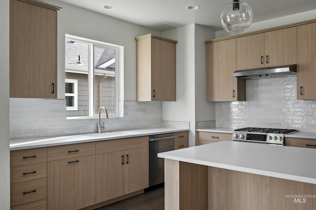 kitchen with backsplash, light brown cabinets, sink, and appliances with stainless steel finishes