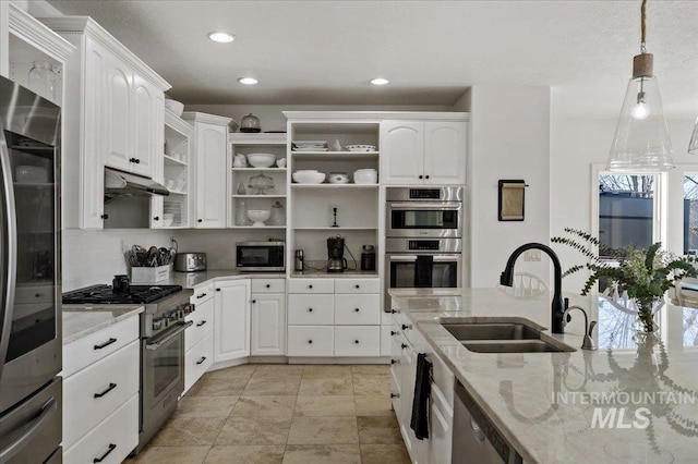 2873 W Wind Dr, Eagle, ID 83616 - kitchen with hanging light fixtures, appliances with stainless steel finishes, white cabinets, and light stone counters