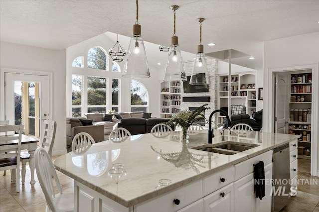 2873 W Wind Dr, Eagle, ID 83616 - kitchen with built in shelves, sink, an island with sink, light stone countertops, and white cabinets