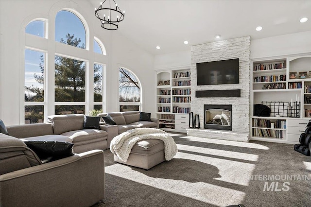 2873 W Wind Dr, Eagle, ID 83616 - carpeted living room with a healthy amount of sunlight, a stone fireplace, and built in features