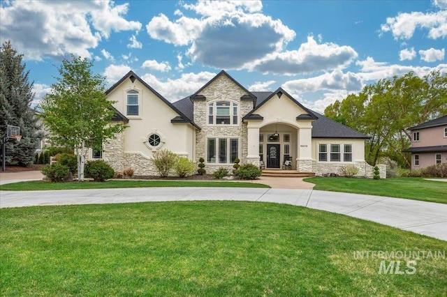 french country style house with a front yard