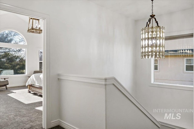 2873 W Wind Dr, Eagle, ID 83616 - hall featuring plenty of natural light, carpet floors, and a chandelier