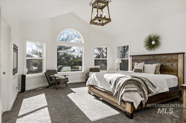2873 W Wind Dr, Eagle, ID 83616 - bedroom featuring dark carpet, vaulted ceiling, multiple windows, and a notable chandelier