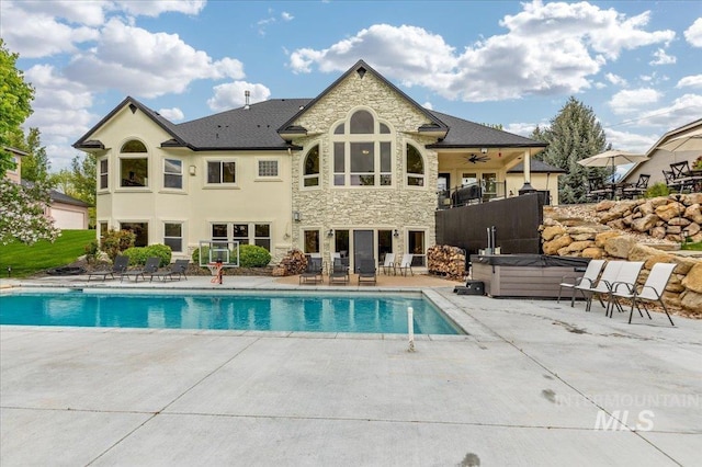 2873 W Wind Dr, Eagle, ID 83616 - view of swimming pool with ceiling fan, a hot tub, and a patio area