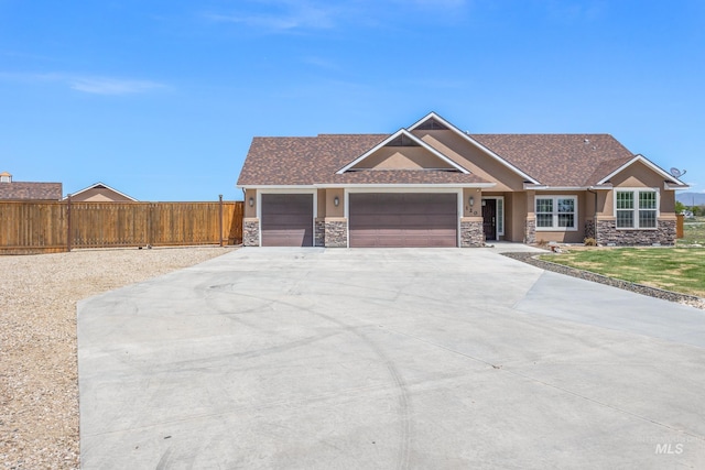 120 S Marko Ln, Kuna, ID 83634 - craftsman-style house featuring stone siding, a garage, driveway, and stucco siding