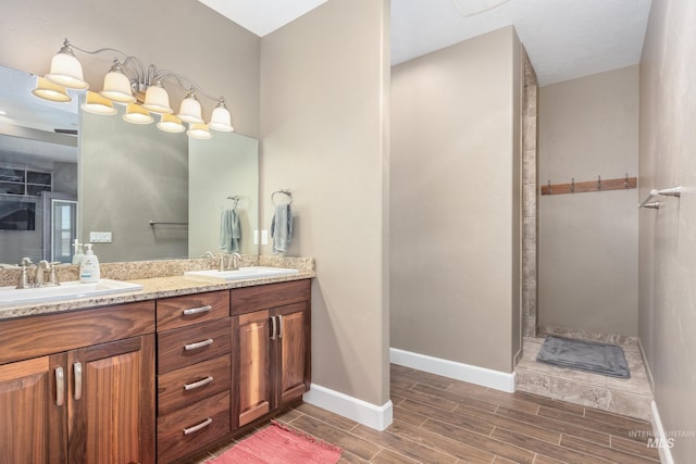 120 S Marko Ln, Kuna, ID 83634 - bathroom with wood finish floors, double vanity, baseboards, and a walk in shower
