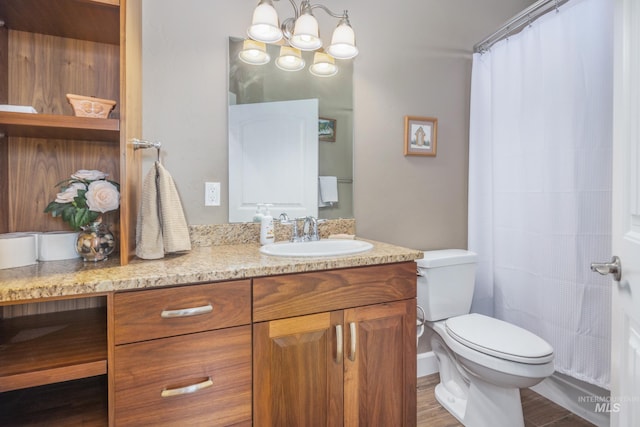 120 S Marko Ln, Kuna, ID 83634 - full bath with vanity, toilet, wood finished floors, a chandelier, and a shower with curtain