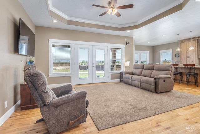 120 S Marko Ln, Kuna, ID 83634 - living room with a tray ceiling, crown molding, french doors, wood finished floors, and ceiling fan