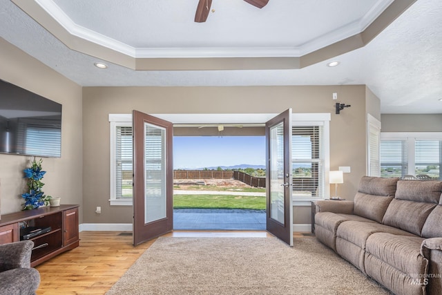 120 S Marko Ln, Kuna, ID 83634 - living area with crown molding, a tray ceiling, recessed lighting, light wood finished floors, and a ceiling fan