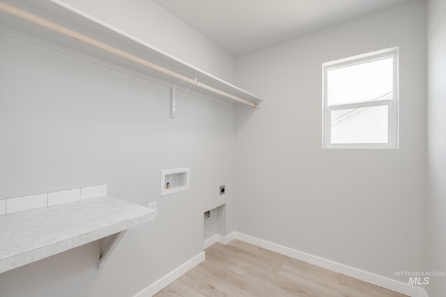 12596 Kinsella St, Nampa, ID 83651 - washroom featuring laundry area, light wood-type flooring, electric dryer hookup, baseboards, and hookup for a washing machine