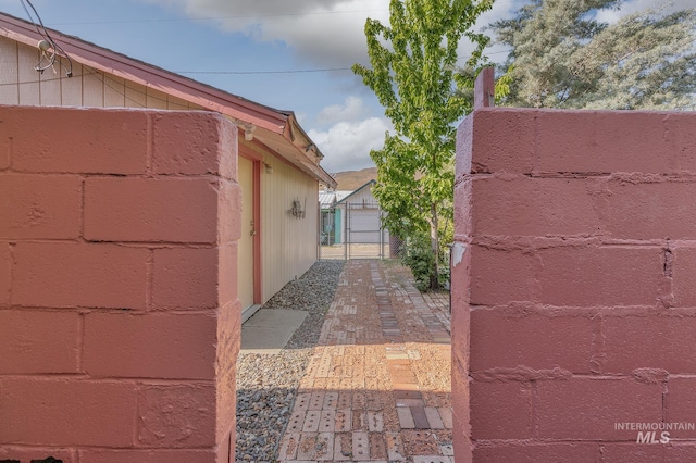 view of property exterior featuring a gate and fence