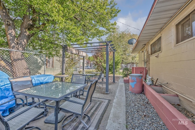 view of patio / terrace with a pergola, outdoor dining area, and fence