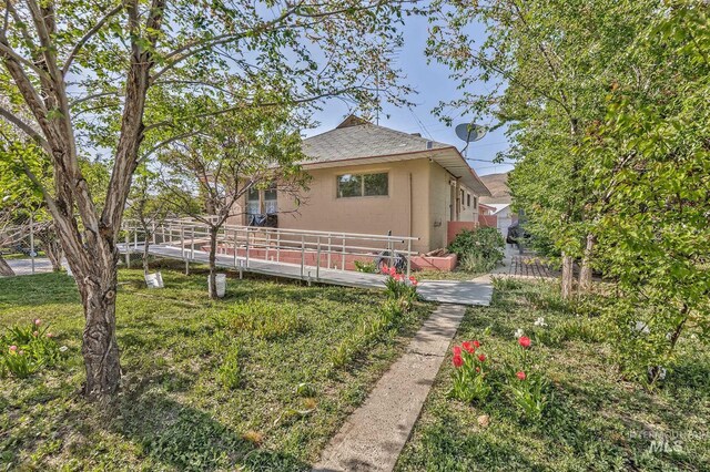 view of front of home featuring a shingled roof and fence