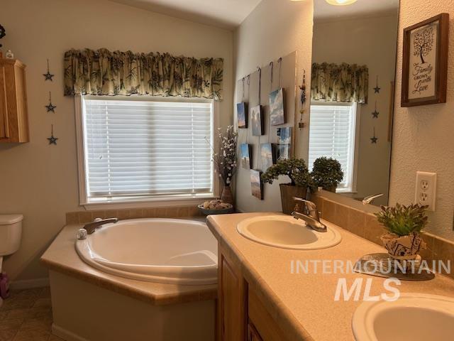 16 E 300 S Unit 16E 300S, Fairfield, ID 83327 - bathroom with a bath, double vanity, toilet, and tile patterned floors