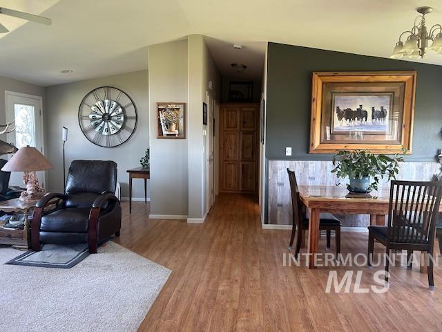 16 E 300 S Unit 16E 300S, Fairfield, ID 83327 - living room featuring light wood-style floors, a chandelier, baseboards, and ceiling fan