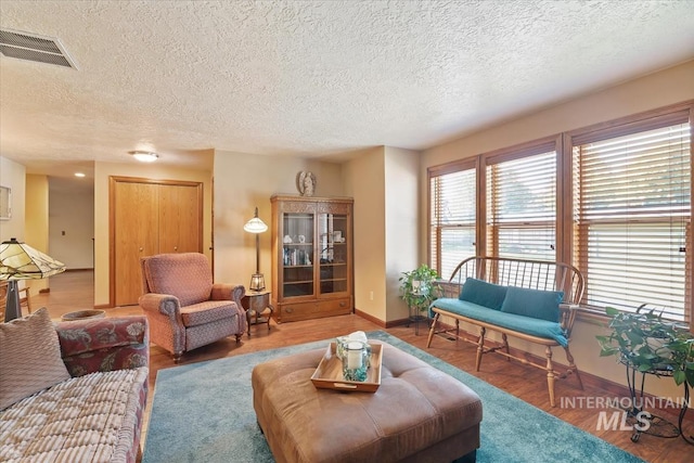 1460 Fairway Ct, Mountain Home, ID 83647 - living room with a textured ceiling, healthy amount of natural light, and wood finished floors